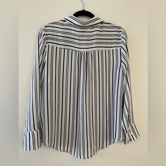 This blouse is white with black vertical stripes.  It’s a little bit sheer. - Picture 5 of 5